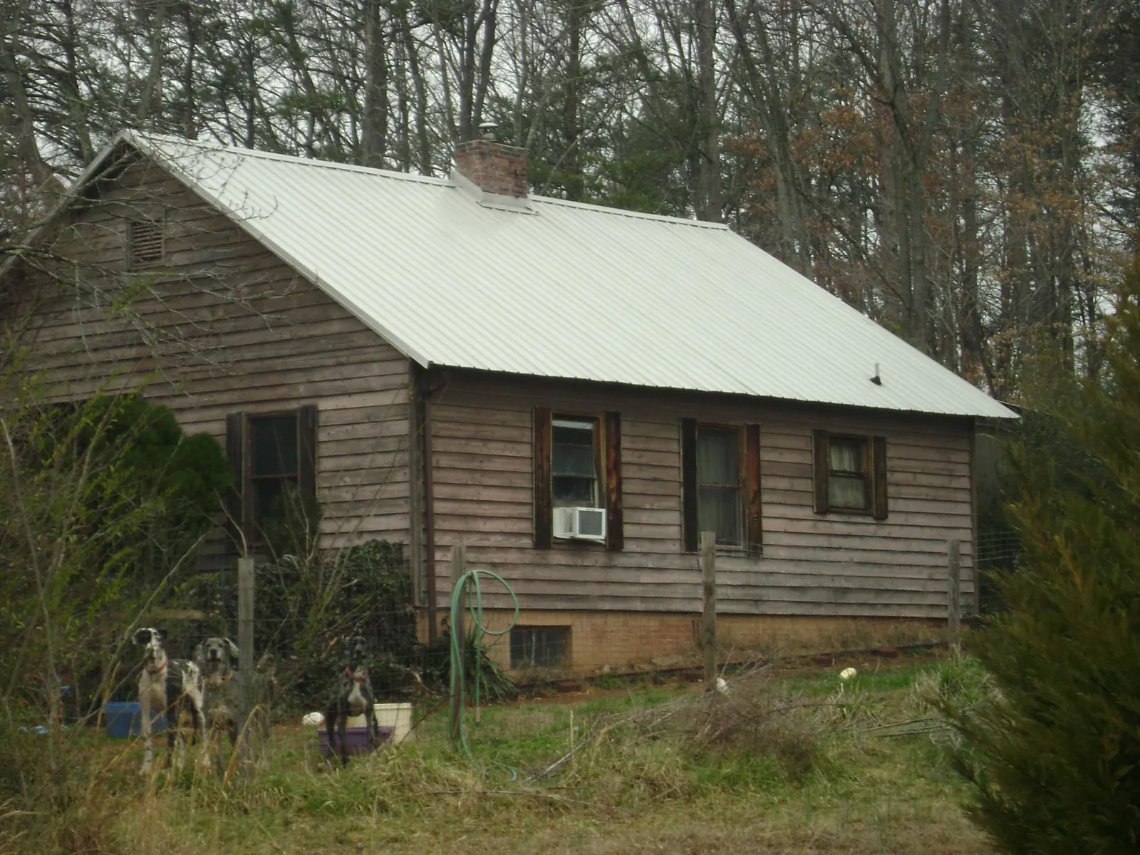 White metal roof on an old wood sided farmhouse, from a Metal Roof Installation job in Mayo